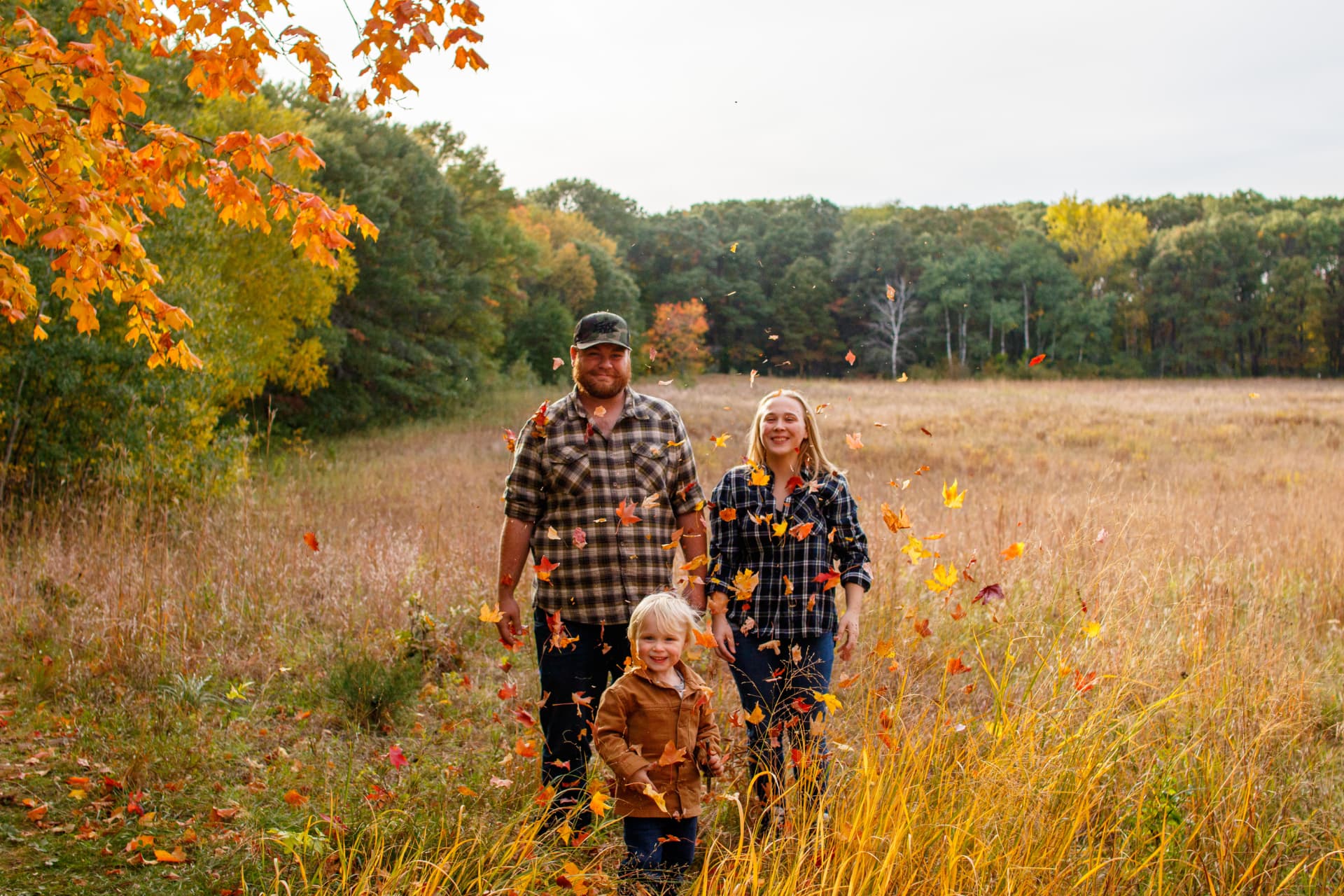 The Isaacs family walking through a fall field