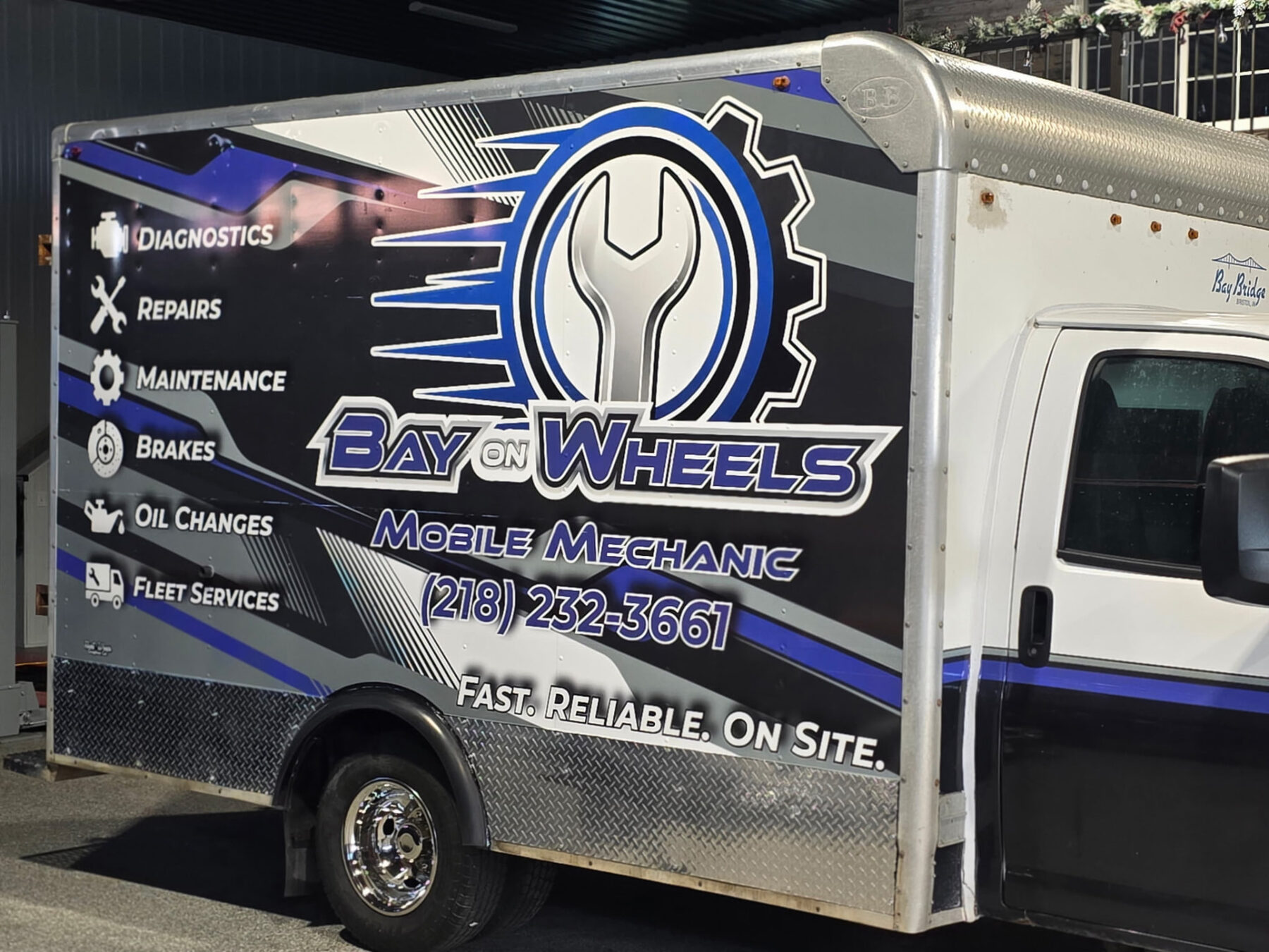 Close up of the Bay On Wheels mobile mechanic truck wrap
